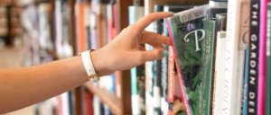 hand reaching out for book at library
