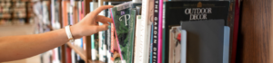 hand reaching out for book at library