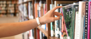 hand reaching out for book at library