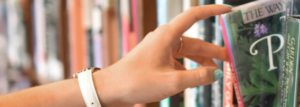 hand reaching out for book at library