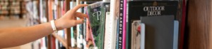 hand reaching out for book at library