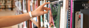 hand reaching out for book at library