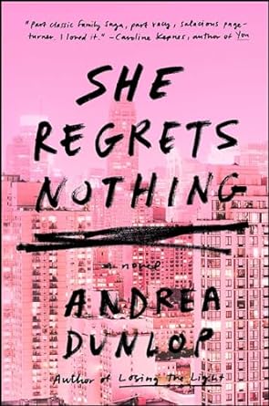 "She Regrets Nothing" by Andrea Dunlop with a hazy sunset pink cover that shows the New York skyline. The title and author's name are in handwritten style in jet black above it.